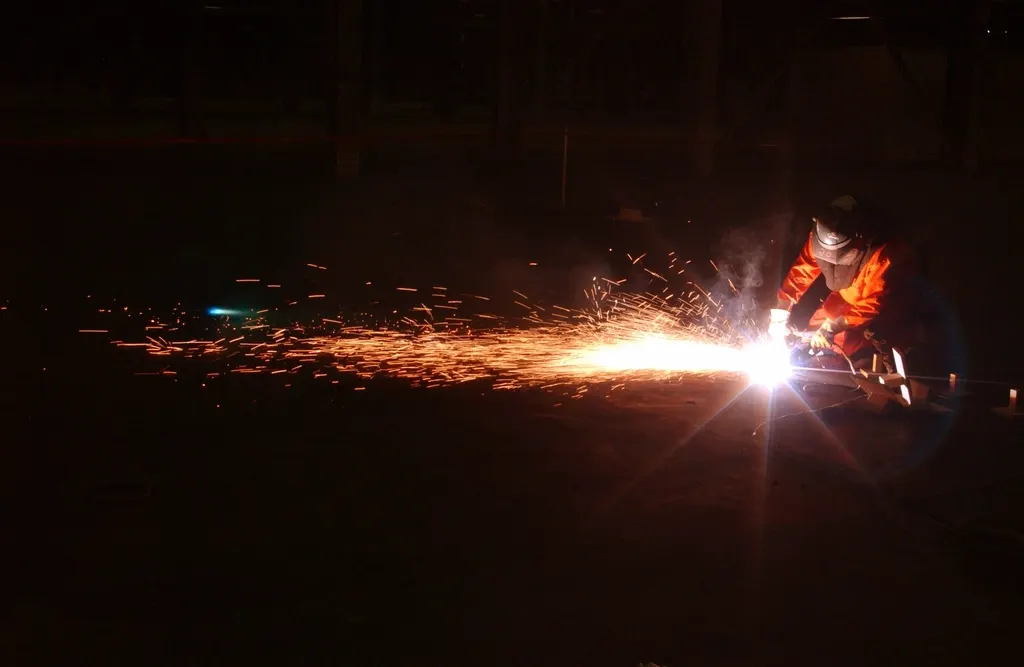 Welder at work with sparks